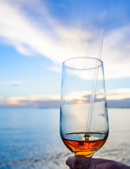 a glass of wine on the background of the sea s