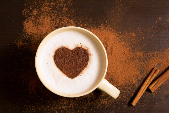 Fototapeta Cup of coffee with heart pattern of cinnamon