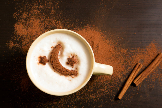 Cup of coffee with moon and stars pattern of cinnamon