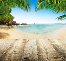 Empty wooden planks with tropical beach on background