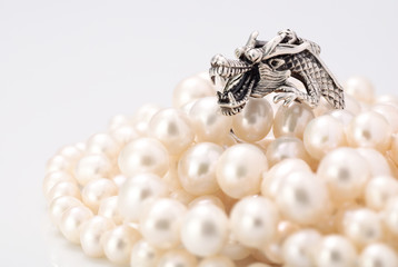 Pearls and silver dragon - macro foto with place for a text. Sha