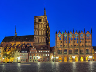 Stralsund, Germany. Night view of Old Market square with Nicholas' Church and City Hall in brick gothic style. - obrazy, fototapety, plakaty