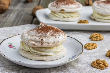 Detail on Walnuts Meringue with cocoa on white plate