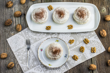 Top View on Walnuts Meringues with cocoa on white board with for
