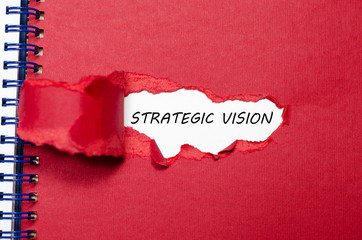 The word strategic vision appearing behind torn paper