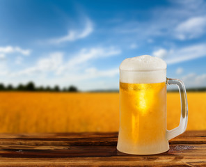 cold glass mug of beer in a landscape