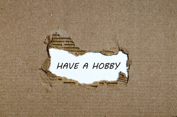 The word have a hobby appearing behind torn paper