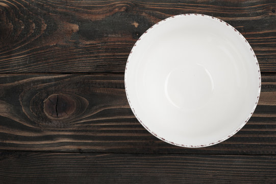Empty plate over wooden table