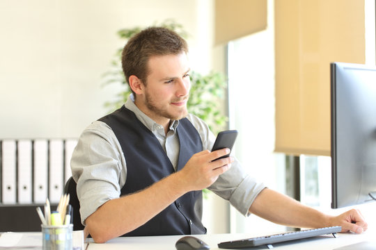Businessman working with phone and computer