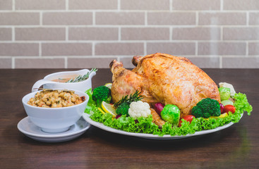 Roasted turkey stuffing garnished with Vegetables served with gravy sauce on a rustic style table. Christmas Dinner