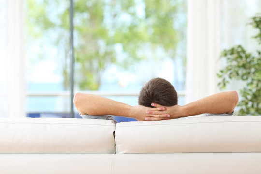 Man relaxed on a couch at home