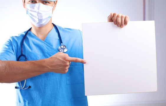 close up of doctor holding blank white banner
