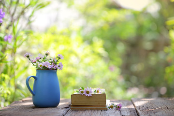 flower in blue pot and notebooks