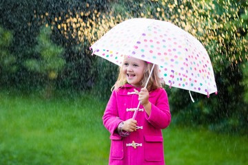 Little girl with umbrella in the rain
