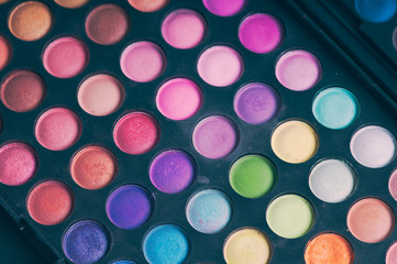 Make-up colorful eyeshadow palettes isolated on black background