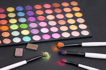 Make-up colorful eyeshadow palettes isolated on black background