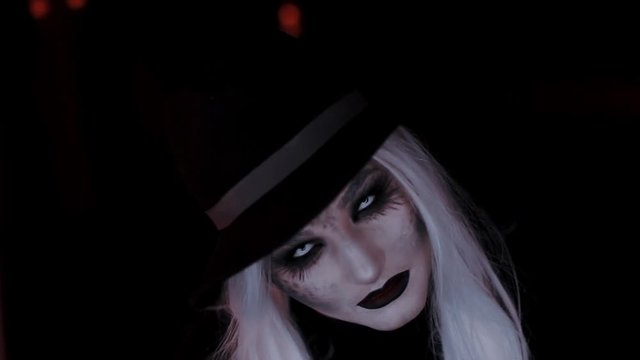 girl in the image of a witch hat. Black background