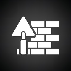 Icon of brick wall with trowel