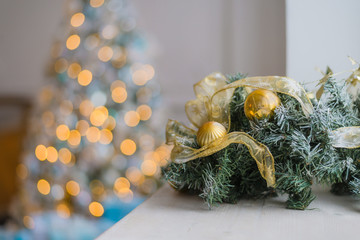 Gold and blue Christmas background of de-focused lights with decorated tree
