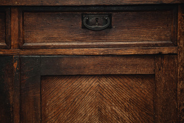 detail of a vintage cupboard (sideboard) - drawers with metal handle. vintage retro furniture closeup. piece of furniture made of natural wood