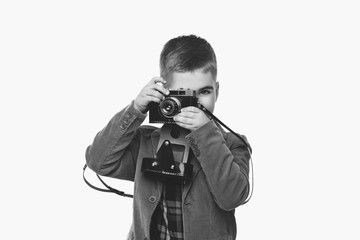 Handsome young boy with retro camera