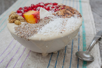 vegan banana smoothie with pomegranate, mulberry, coconut, Chia, carob. Raw fruit energy food. Detof and healthy breakfast bowl. 