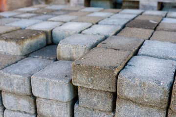 Stack of small rectangular concrete pavers.