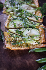 Open pie, pizza with green vegetables.