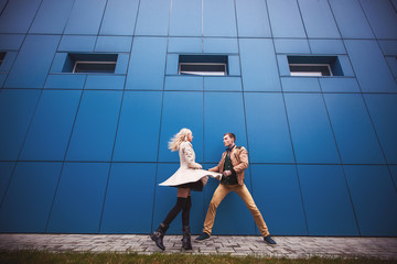 Couple dancers dancing on the blue wall backkground. Ballroom concept