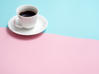 Obraz na płótnie Canvas Top view of colorful cup of coffee on blue and pink background (flat lay)