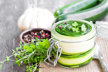 Sliced  zucchini with parsley and garlic preserves in glass jar