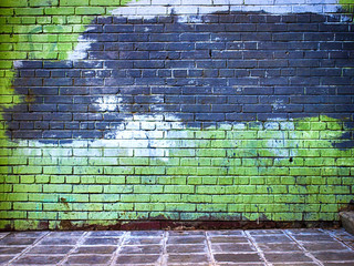 green brick wall getting older from the bottom