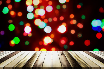 Christmas bokeh background with empty wooden table. Perfect for display