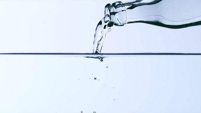 Mineral water being poured. Fresh stream on water surface 