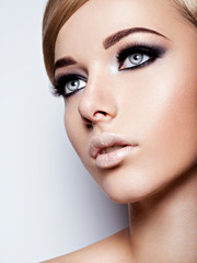  Portrait of fashion model with  black makeup of eyes. Pretty at