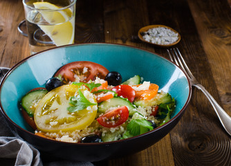 Tabbouleh salad on dark wooden background