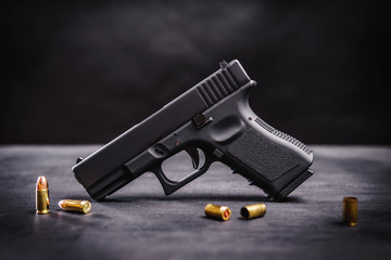 black 9mm pistol on a black wooden table