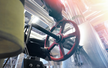 factory worker turning valve