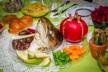 Fototapeta na wymiar Rosh Hashanah, dish with the fish head, fruits and vegetables