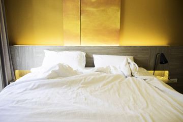 Close up white bedding sheets and pillow on natural stone wall r