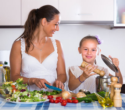 Woman Teaching Girl To Cook