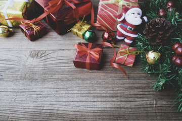 Christmas background with decorations and gift boxes on wooden b