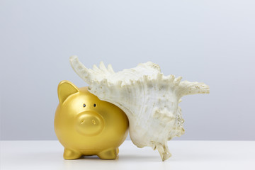 concept : "saving for travel" gold piggy bank with Giant clam