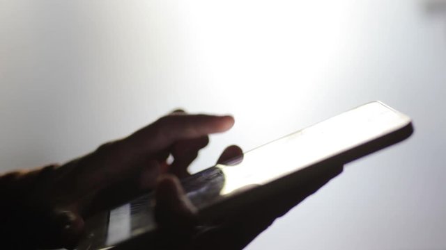 Footage of a person's hands using a tablet.
