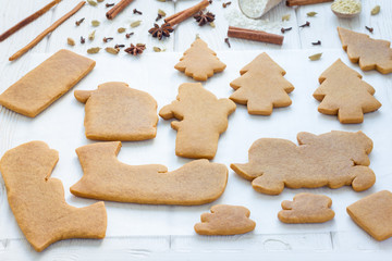 Baked gingerbread cookies for christmas 3D composition on wooden table, spices on background, horizontal