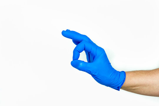 Ok sign. Hand with blue medical glove in profile view on white background.