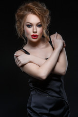 Naklejka premium Beautiful girl in black classic dress