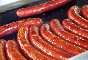Cooking meat sausages on the grill