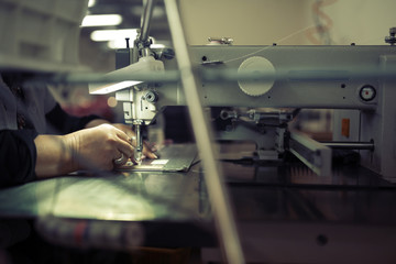 Worker in textile industry sewing