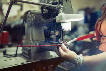 Fototapeta na wymiar Worker in textile industry sewing